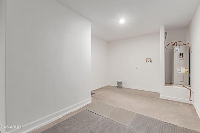 laundry area featuring baseboards and electric water heater