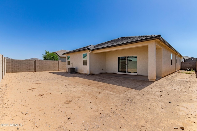 rear view of property featuring a fenced backyard, a patio, stucco siding, and central air condition unit