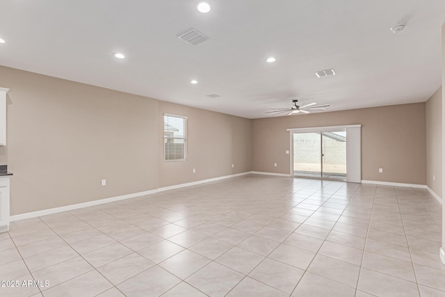 empty room with ceiling fan, light tile patterned flooring, and visible vents
