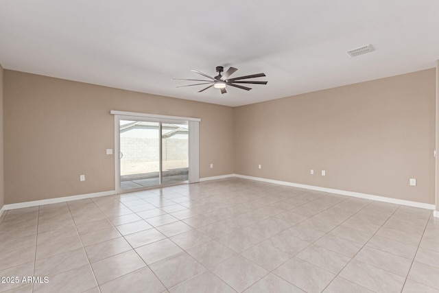 empty room with light tile patterned floors, baseboards, a ceiling fan, and visible vents