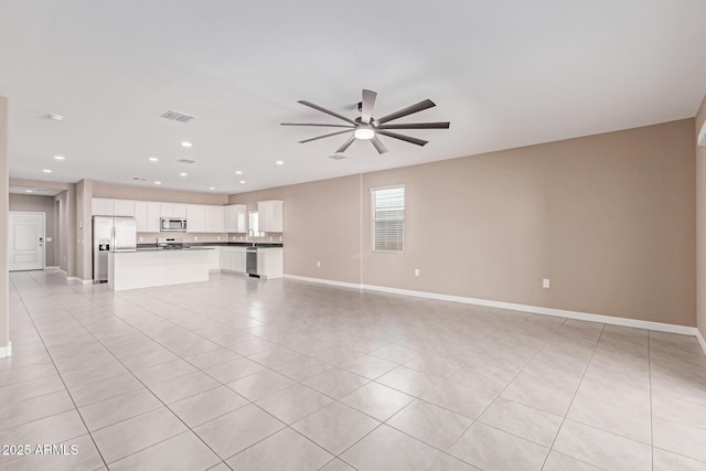 unfurnished living room with a ceiling fan, visible vents, baseboards, recessed lighting, and light tile patterned flooring