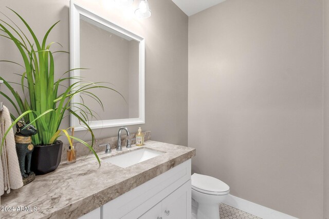 bathroom with tile patterned floors, vanity, and toilet