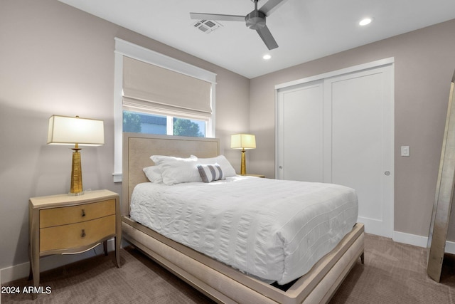 carpeted bedroom with ceiling fan and a closet