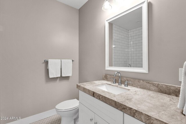 bathroom with tile patterned floors, vanity, and toilet