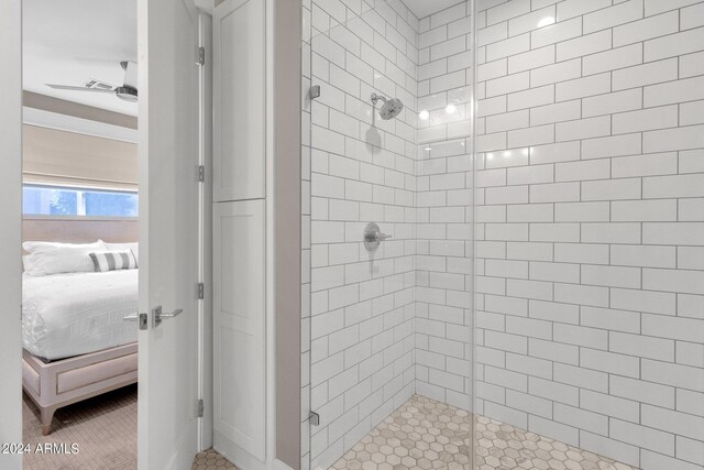 bathroom featuring ceiling fan, tile patterned floors, and an enclosed shower