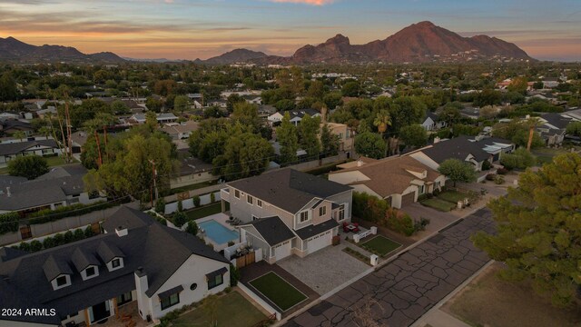 aerial view at dusk featuring a mountain view