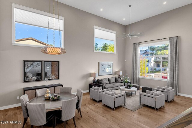 living room with light hardwood / wood-style floors and ceiling fan