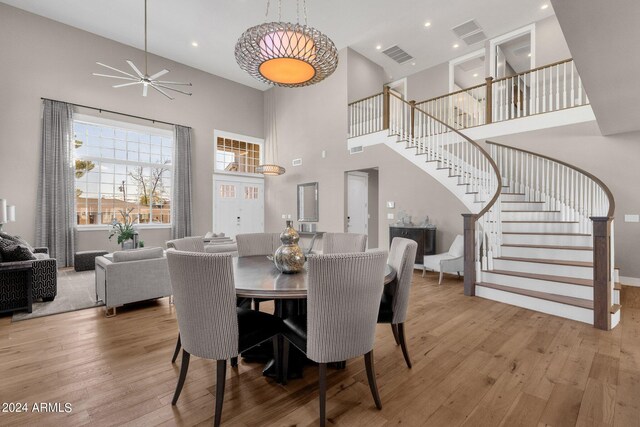 dining area featuring ceiling fan, light hardwood / wood-style floors, and high vaulted ceiling