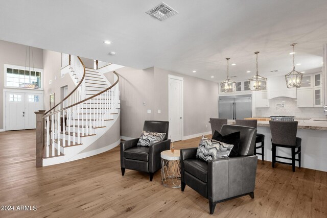 interior space featuring light wood-type flooring and a chandelier