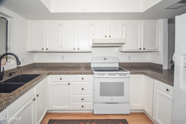 kitchen featuring dark stone counters, white electric stove, sink, light hardwood / wood-style flooring, and white cabinets