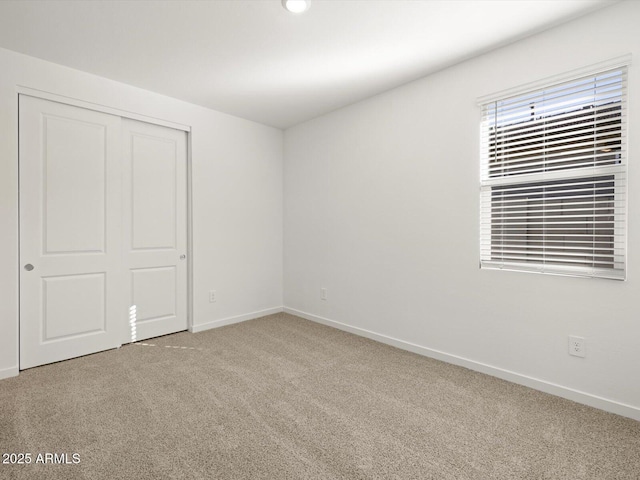 unfurnished bedroom with a closet and carpet