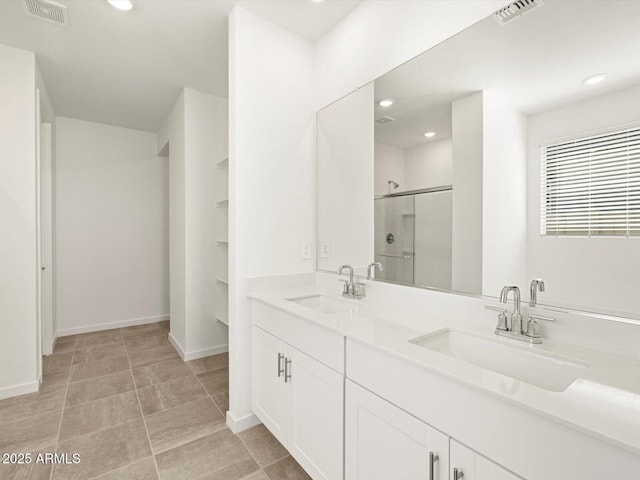 bathroom featuring an enclosed shower and vanity