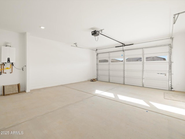 garage with tankless water heater and a garage door opener