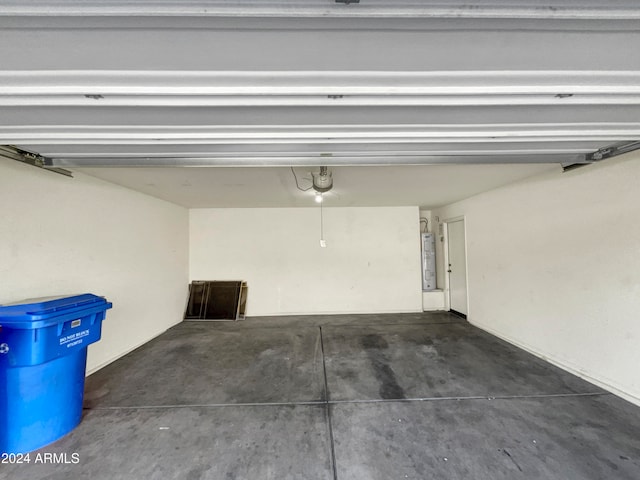 garage featuring a garage door opener and water heater