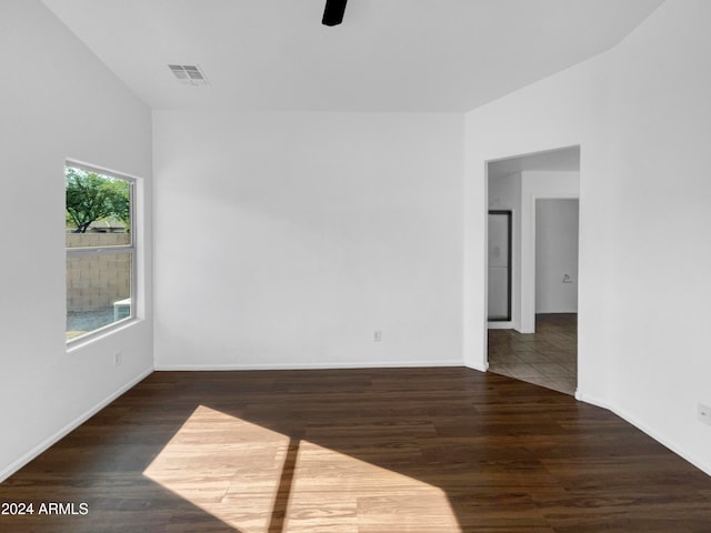 empty room with dark hardwood / wood-style floors and ceiling fan