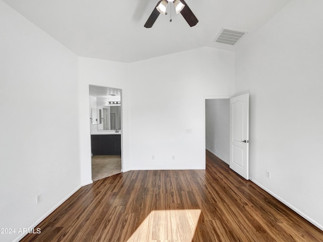 unfurnished room with dark hardwood / wood-style flooring, ceiling fan, and lofted ceiling