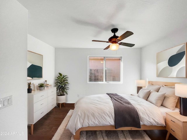 bedroom with ceiling fan and dark hardwood / wood-style floors