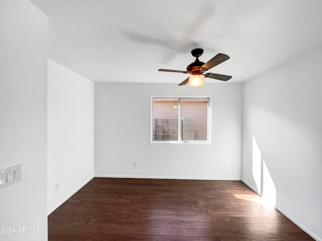 empty room featuring ceiling fan and dark wood-type flooring