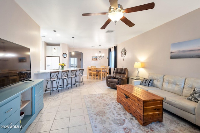 living room featuring ceiling fan, visible vents, and light tile patterned flooring