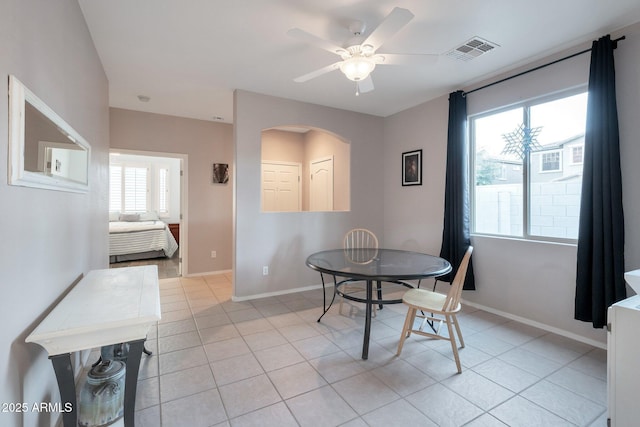 dining space featuring light tile patterned floors, baseboards, visible vents, and a ceiling fan