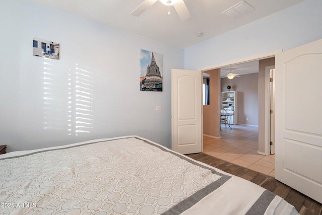 unfurnished bedroom with baseboards, visible vents, a ceiling fan, and wood finished floors