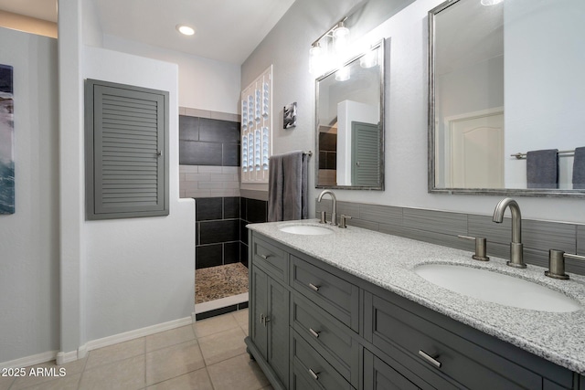 full bath with tile patterned flooring, double vanity, a sink, and a walk in shower