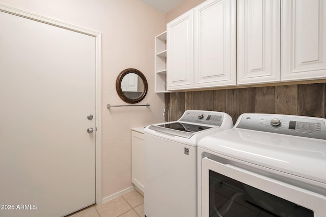 clothes washing area with light tile patterned floors and washing machine and dryer