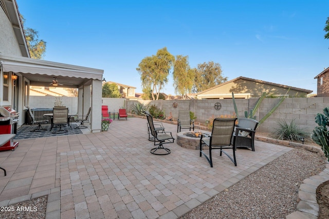 view of patio with an outdoor fire pit, a fenced backyard, grilling area, and outdoor dining space