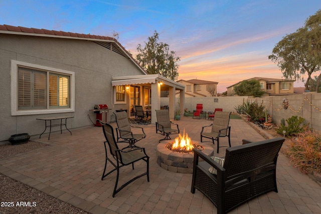 view of patio / terrace featuring an outdoor fire pit and a fenced backyard