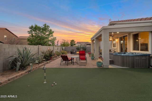 exterior space with a fenced backyard and a hot tub