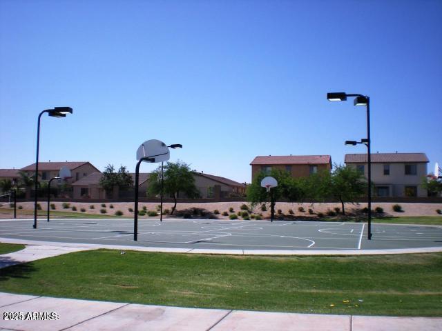 view of basketball court featuring community basketball court and a lawn