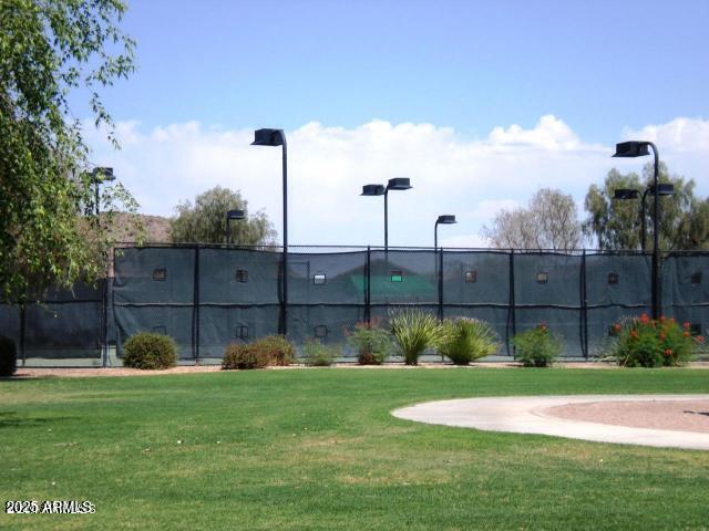 surrounding community with fence and a lawn