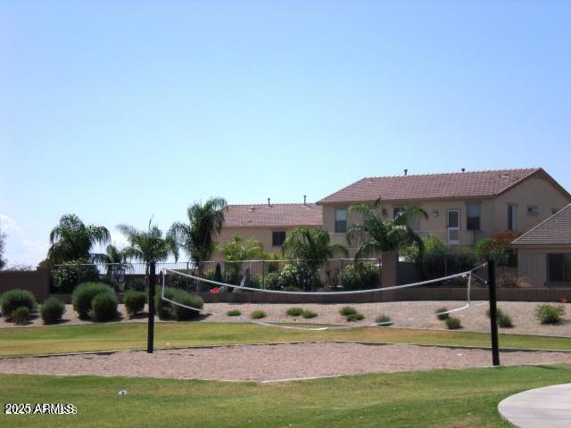 surrounding community featuring a yard and volleyball court