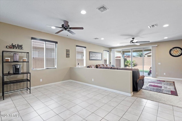 living room featuring light tile patterned flooring, recessed lighting, visible vents, and baseboards