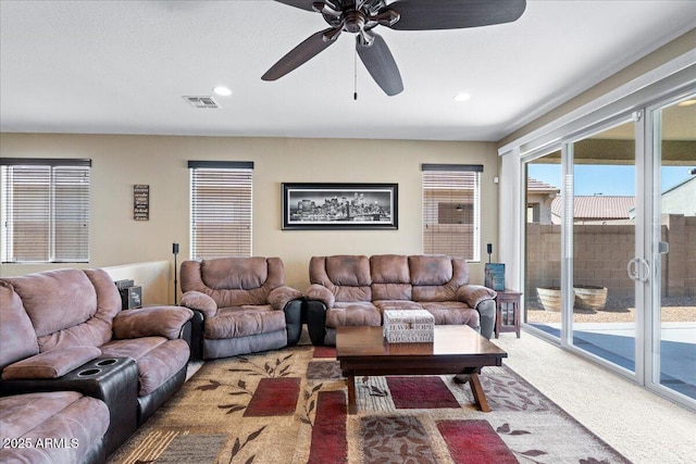 living area with recessed lighting, visible vents, light colored carpet, and a ceiling fan