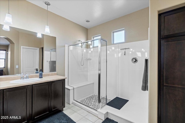 bathroom featuring tile patterned floors, a stall shower, and vanity