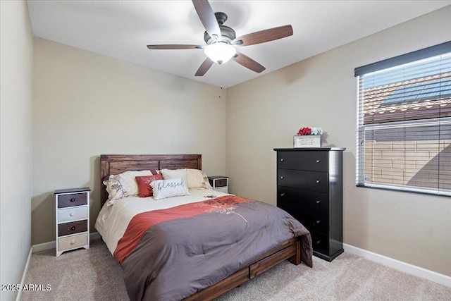 bedroom with baseboards, light colored carpet, and a ceiling fan