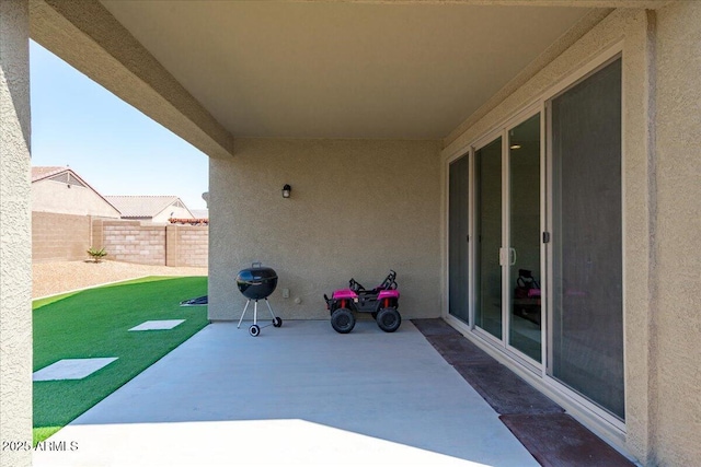 view of patio featuring fence