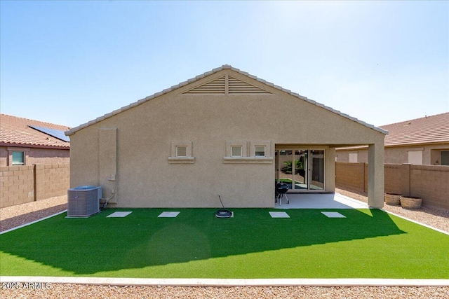 back of property featuring stucco siding, cooling unit, and a fenced backyard