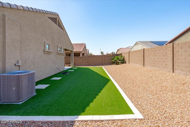 view of yard with cooling unit and a fenced backyard