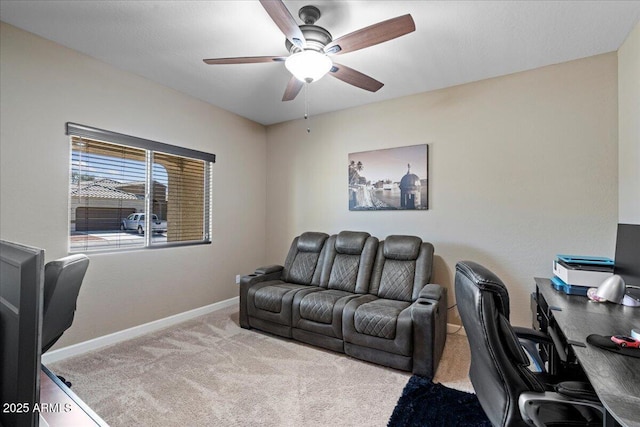 office space with baseboards, carpet, and ceiling fan