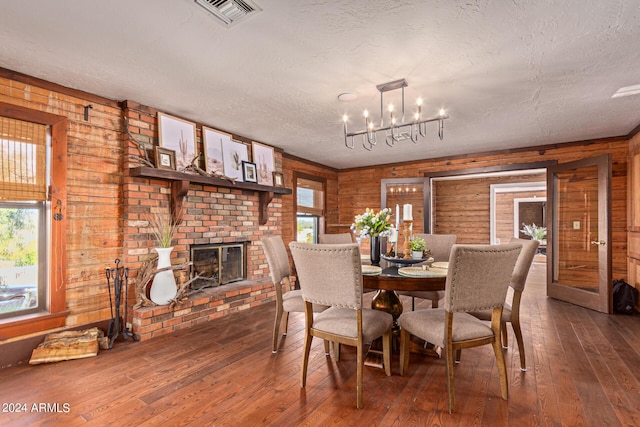 dining room with hardwood / wood-style floors and wooden walls