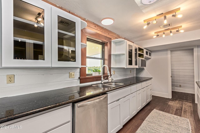 kitchen featuring dishwasher, sink, dark hardwood / wood-style flooring, dark stone counters, and white cabinets