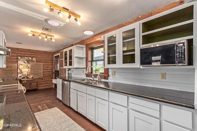 1060 S Kellis Rd, Wickenburg, AZ 85390 - kitchen with open shelves, stainless steel appliances, rustic walls, white cabinets, and a textured ceiling