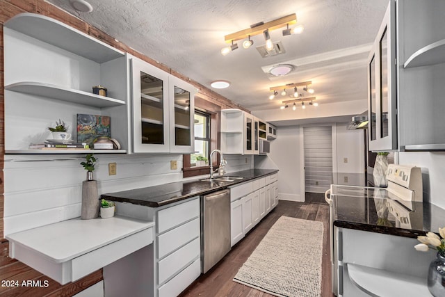 kitchen featuring sink, a textured ceiling, dark hardwood / wood-style flooring, white cabinetry, and stainless steel appliances