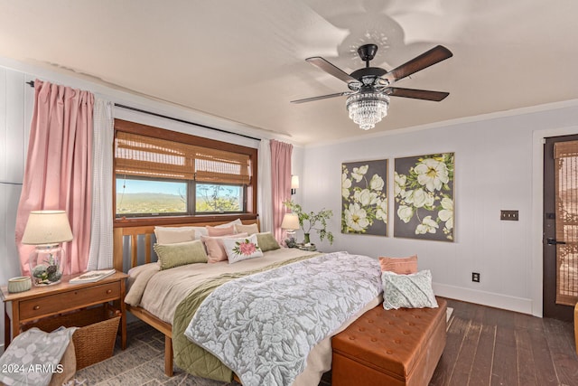 bedroom featuring dark hardwood / wood-style flooring, ceiling fan, and ornamental molding