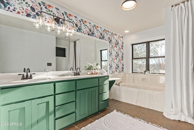 bathroom featuring tile patterned flooring, vanity, and tiled tub