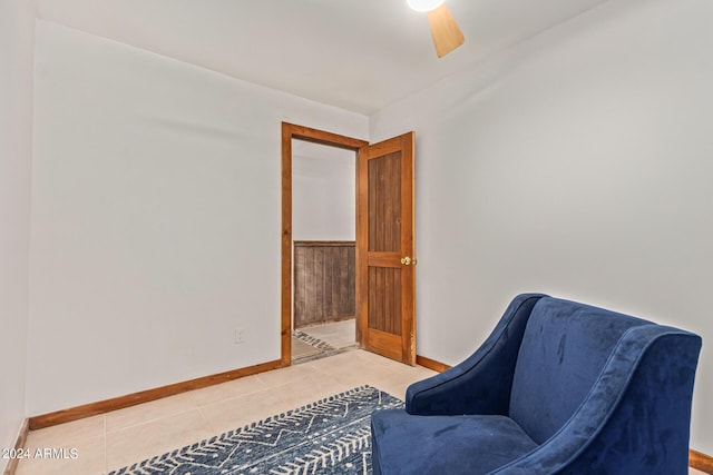 sitting room featuring tile patterned floors and ceiling fan