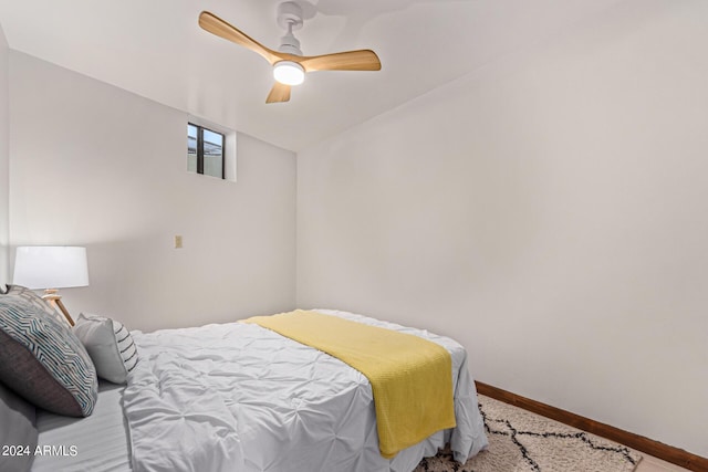 bedroom with ceiling fan, wood-type flooring, and lofted ceiling