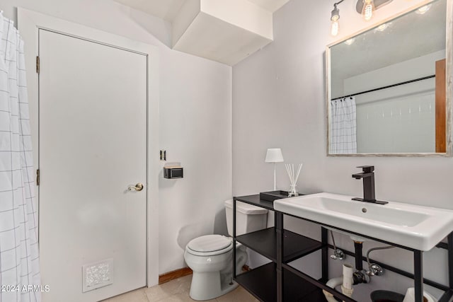 bathroom with tile patterned flooring, a shower with shower curtain, toilet, and sink